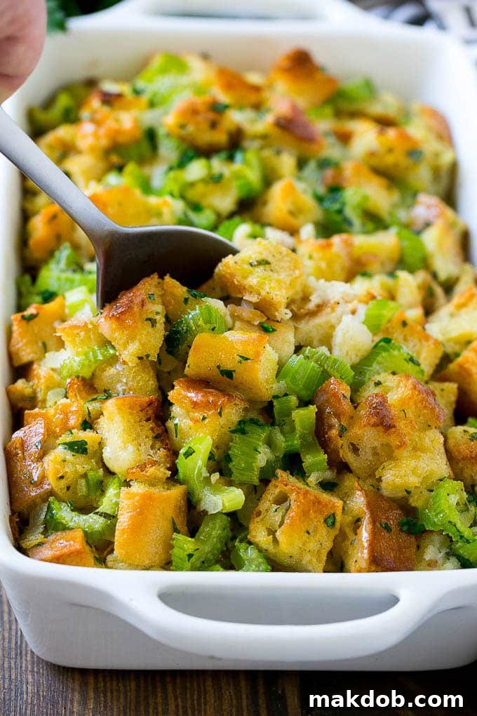 Served Turkey Stuffing for a Delicious Holiday Meal Golden-brown turkey stuffing in a casserole dish with a serving spoon, garnished with fresh parsley.