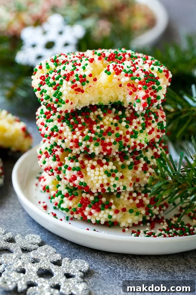 A perfectly stacked pile of gooey butter cookies, with one cookie showing a delicious bite taken out, revealing its soft, gooey interior.