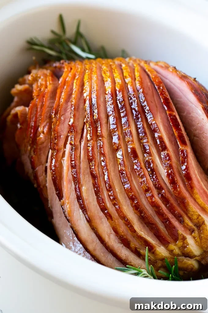 A spiral cut crock pot ham inside a slow cooker.