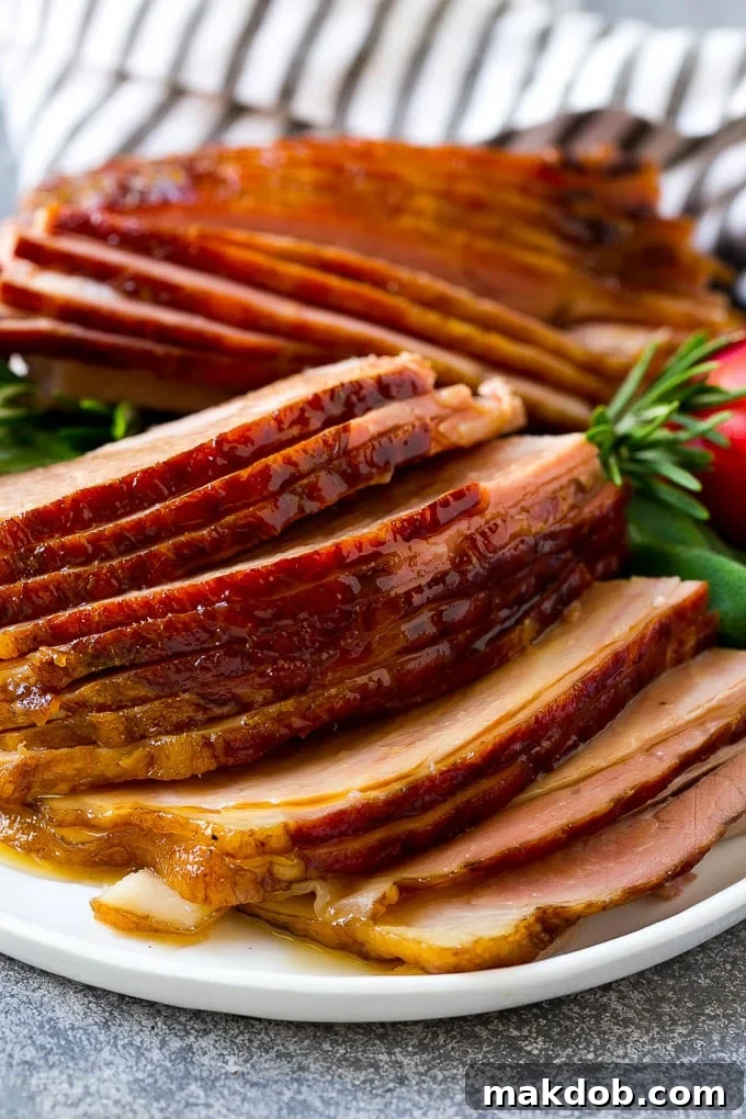 Sliced crock pot ham on a serving plate.