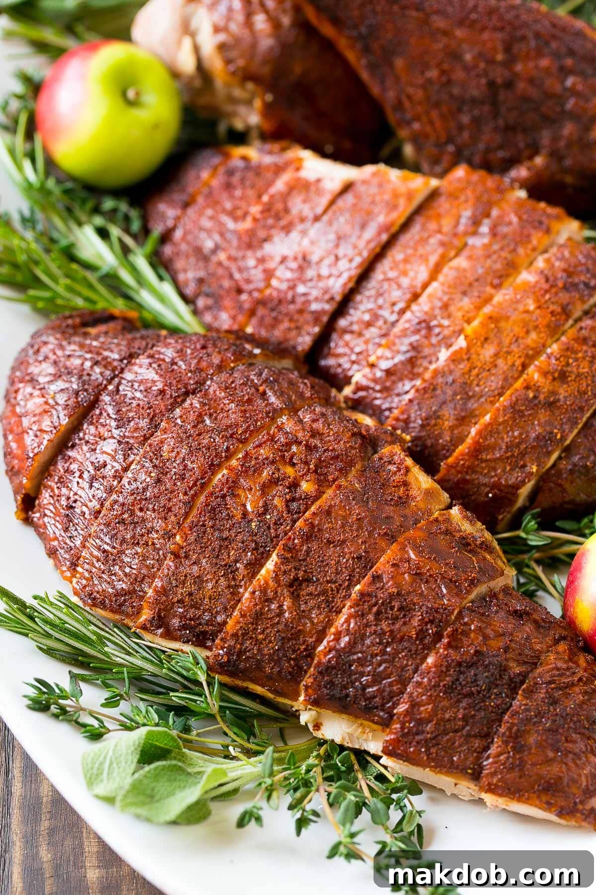 Sliced smoked turkey breast on a plate.