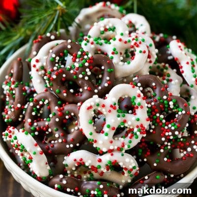 Sweet and Salty Pretzel Delights 2 Chocolate covered pretzels in a bowl with Christmas sprinkles.