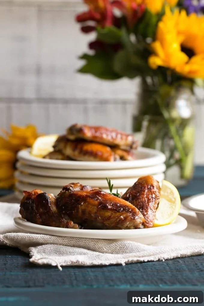 Individual plates with delicious lemon chicken wings, highlighting their golden crisp skin.