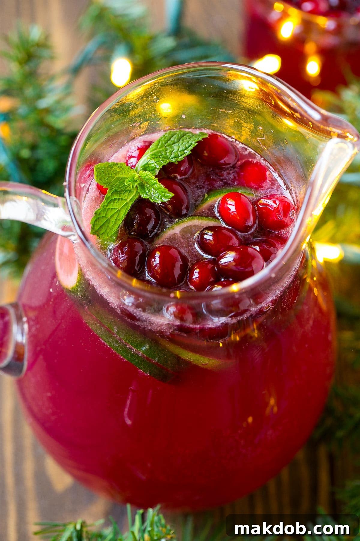 Holiday Glow Punch 6 An overhead view of a pitcher filled with festive cranberry punch, garnished and ready to serve.