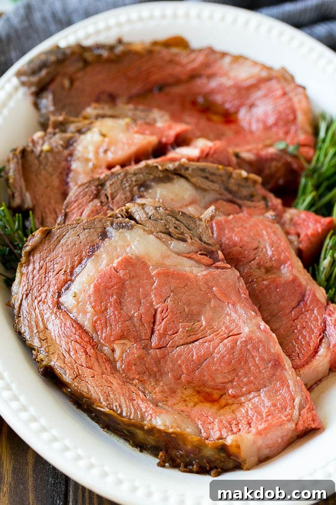 Slices of perfectly cooked beef garnished with fresh herbs, showcasing the beautiful medium-rare doneness.