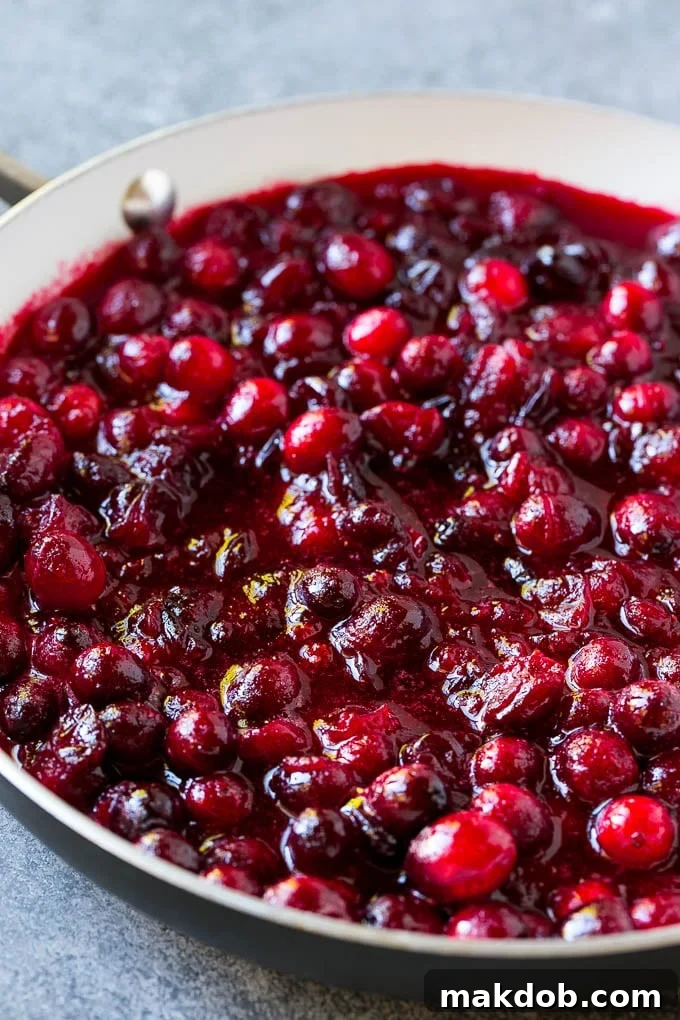 Cranberry orange sauce simmering in a skillet.