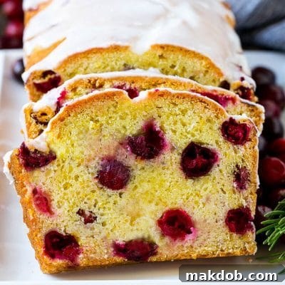 Sliced cranberry bread on a serving plate.