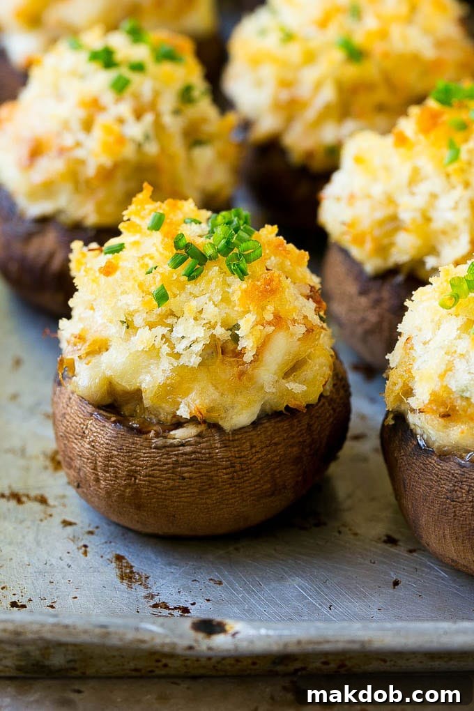 Crab stuffed mushrooms with cremini mushroom caps filled with a creamy seafood filling, beautifully golden brown.