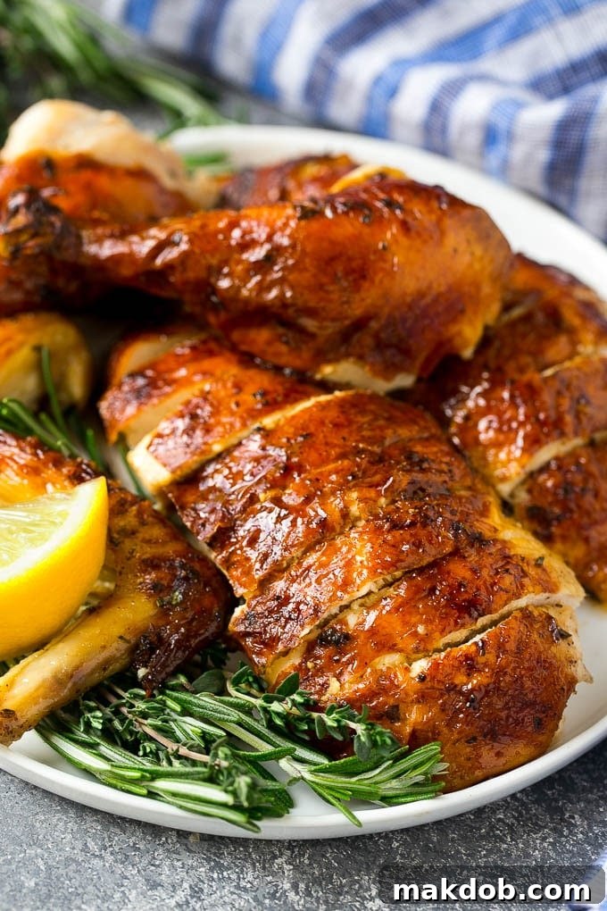 This chicken brine recipe is made with lemons, honey, fresh herbs and spices, and produces a juicy tender chicken every time! A foolproof way for succulent and flavorful roasted, smoked or fried chicken. Perfectly sliced brined chicken breast, showcasing its incredible juiciness and tender texture, elegantly garnished with fresh sprigs of herbs like rosemary and thyme.