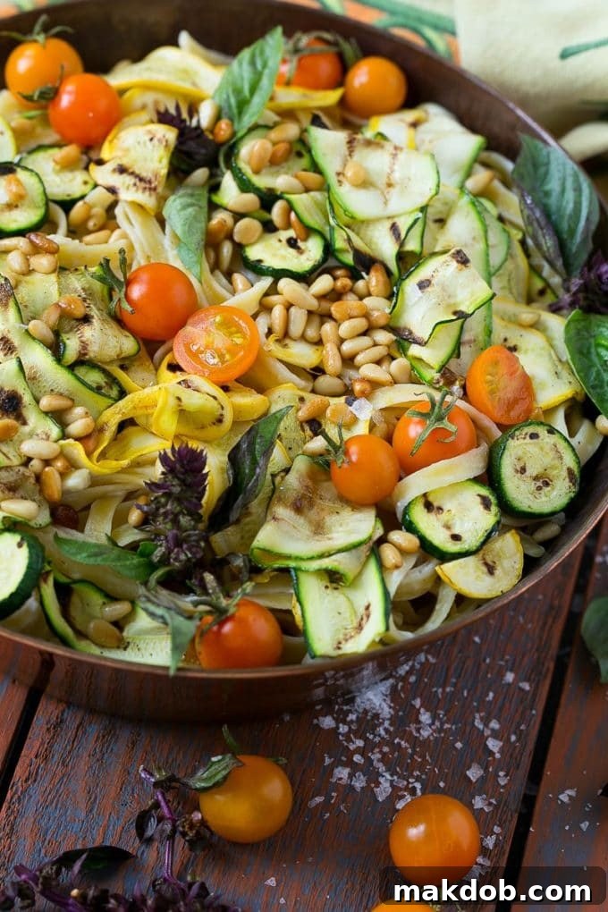 Zucchini Fettuccine Alfredo Recipe | Healthy Zucchini Fettuccine Alfredo | Lighter Zucchini Fettuccine Alfredo | Best Zucchini Fettuccine Alfredo Creamy pasta topped with vibrant grilled zucchini, fresh cherry tomatoes, basil, and toasted pine nuts.