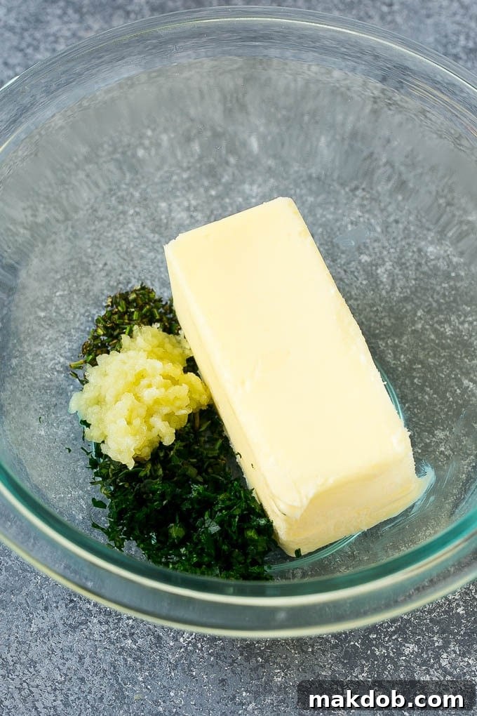 Butter, garlic, fresh minced herbs and salt and pepper in a mixing bowl.