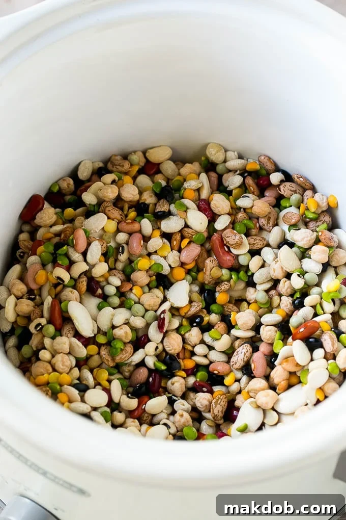 A mixture of dried beans in a crock pot.