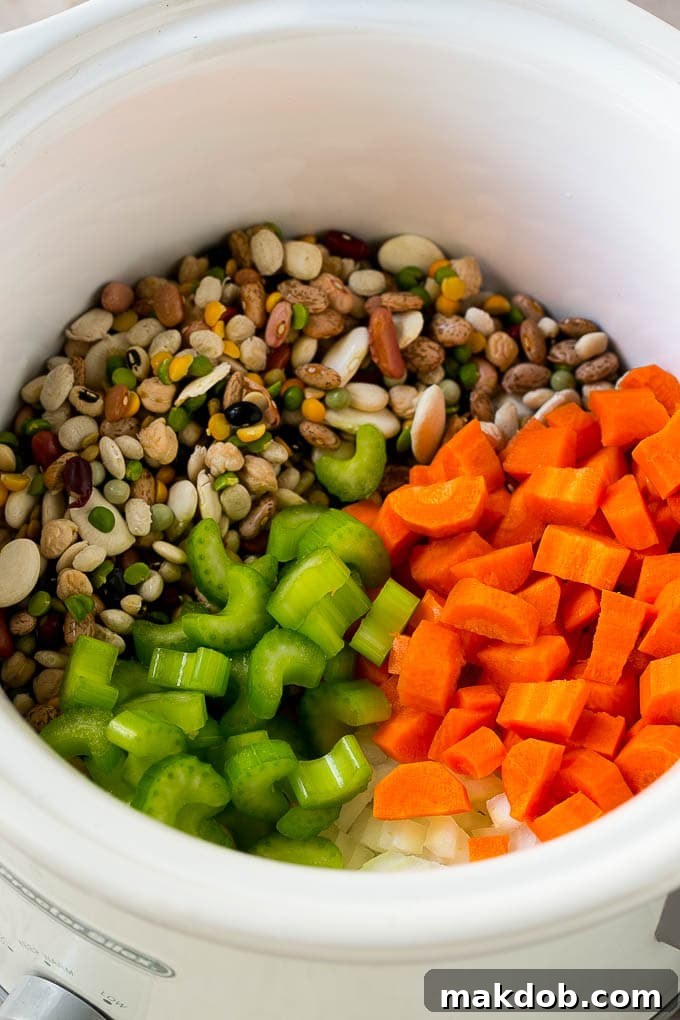Dried beans, carrots, onions and celery in the slow cooker.