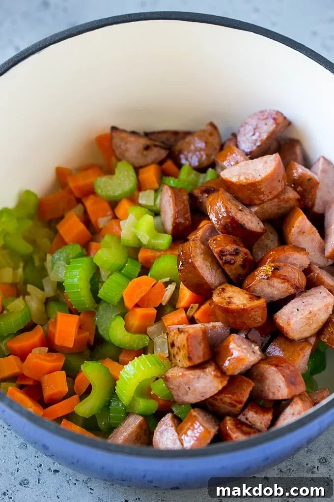 Lentil Soup Recipe | Sausage Lentil Soup #soup #lentils #sausage #dinner #glutenfree #dinneratthezoo Sauteed vegetables and smoked sausage in a pot.