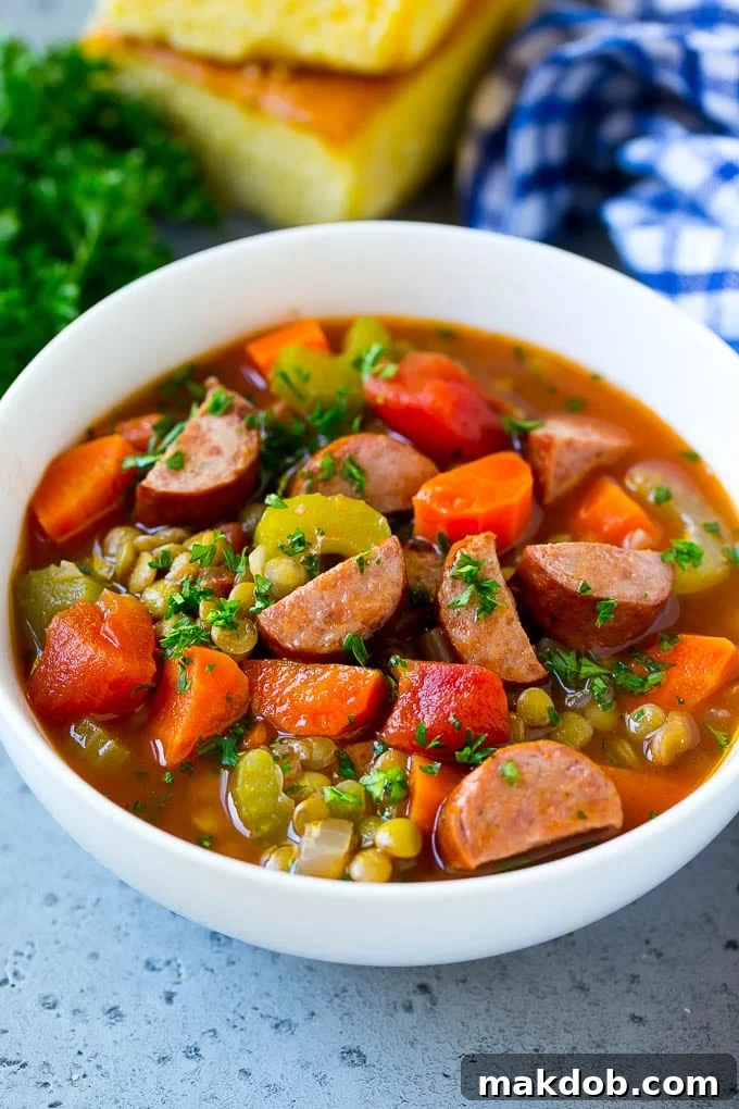 Lentil Soup Recipe | Sausage Lentil Soup #soup #lentils #sausage #dinner #glutenfree #dinneratthezoo A bowl of lentil soup made with smoked sausage and vegetables.