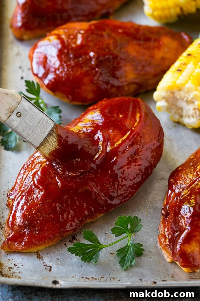 Smoked Chicken Breast Recipe | BBQ Chicken | Smoked Chicken #bbq #chicken #smoker #dinner #glutenfree #dinneratthezoo Smoked chicken breasts being brushed with a rich BBQ sauce, creating a delicious glaze.