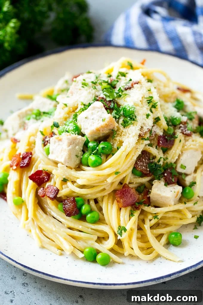 A beautifully plated dish of turkey pasta carbonara, garnished with fresh parsley and a sprinkle of Parmesan cheese, highlighting the rich flavors and inviting textures.