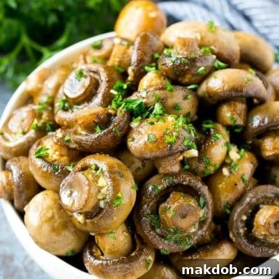 A bowl of roasted mushrooms topped with fresh parsley.