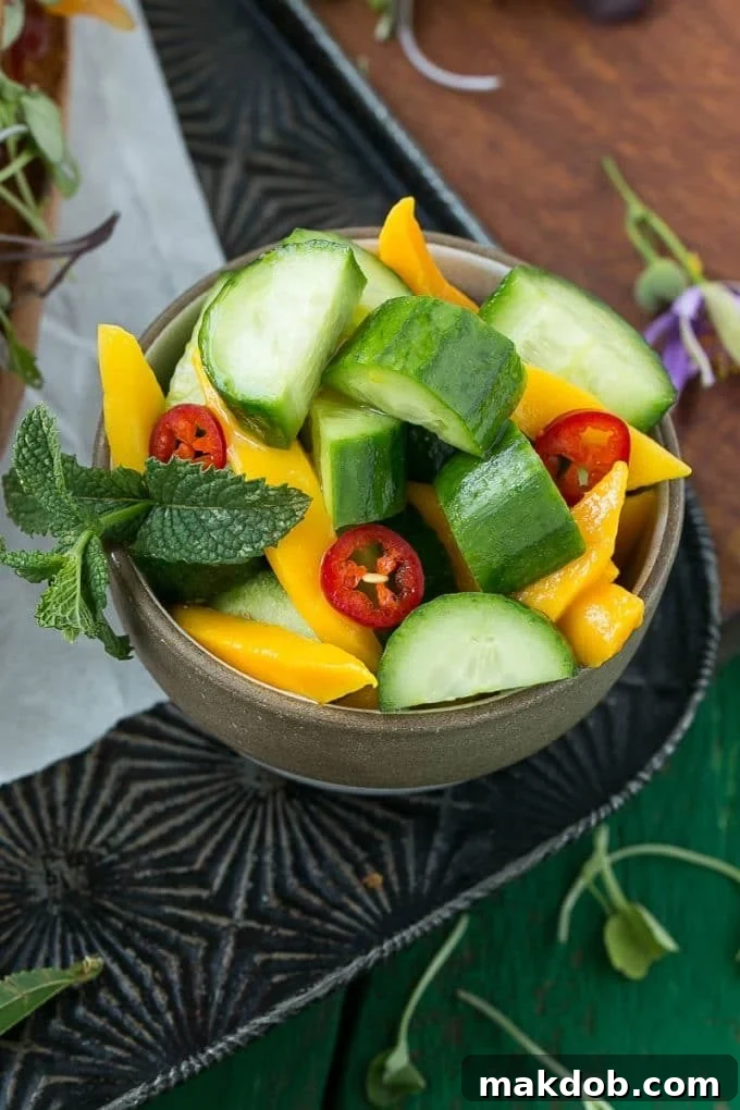 A vibrant Cucumber Mango Salad, featuring crisp cucumber slices and juicy mango chunks, dressed lightly.