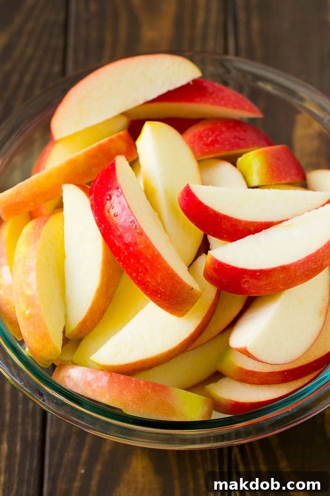 Sliced apples in a mixing bowl.