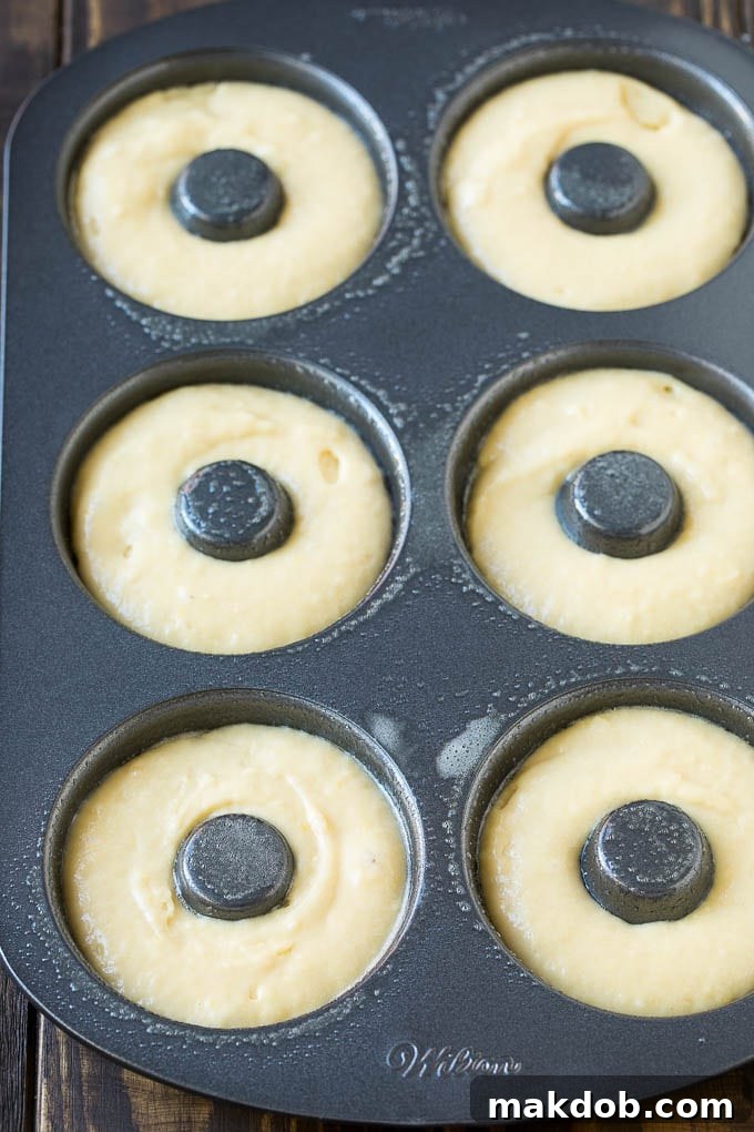 Homemade Baked Donuts 4 A non-stick donut pan, carefully filled with smooth donut batter, ready for baking.