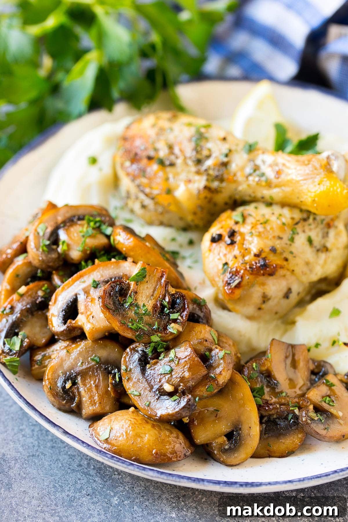 Sauteed mushrooms generously served alongside a succulent chicken breast and creamy mashed potatoes, creating a complete and inviting meal.