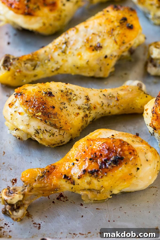 Baked chicken drumsticks on a sheet pan.