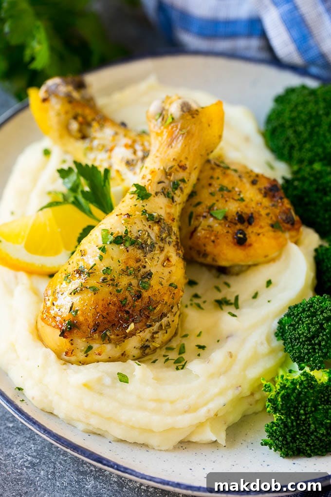 Baked chicken drumsticks served with mashed potatoes and broccoli.