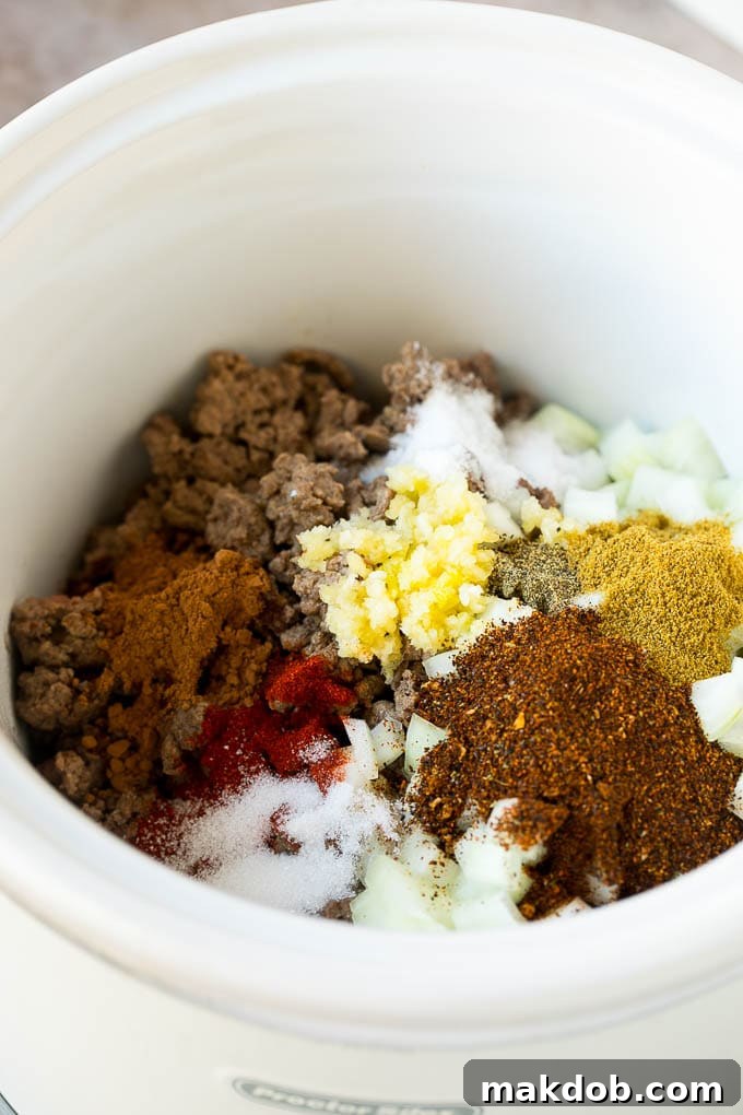 Slow Cooker Chili Recipe | Crock Pot Chili | Beef Chili | Beef and Bean Chili #chili #soup #beef #slowcooker #crockpot #dinner #dinneratthezoo Ground beef, onions and spices in a crock pot.