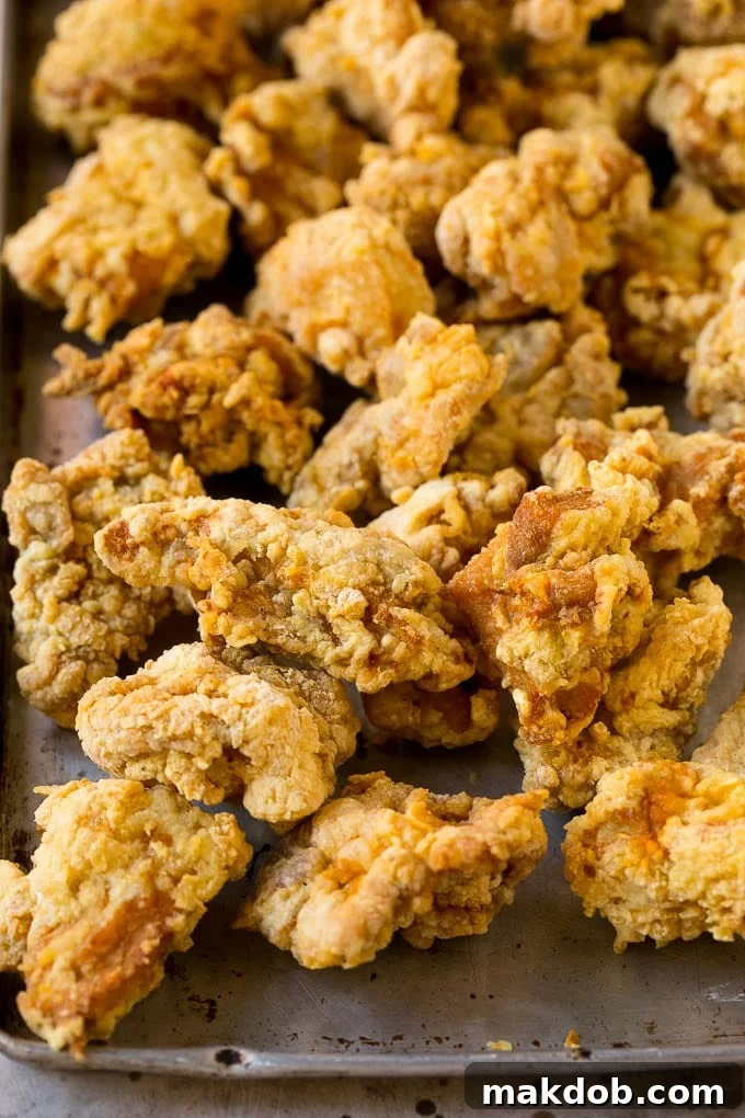 Korean Fried Chicken Recipe | Fried Chicken | Korean Chicken #chicken #friedchicken #appetizer #dinner #dinneratthezoo Fried chicken thigh pieces on a sheet pan.