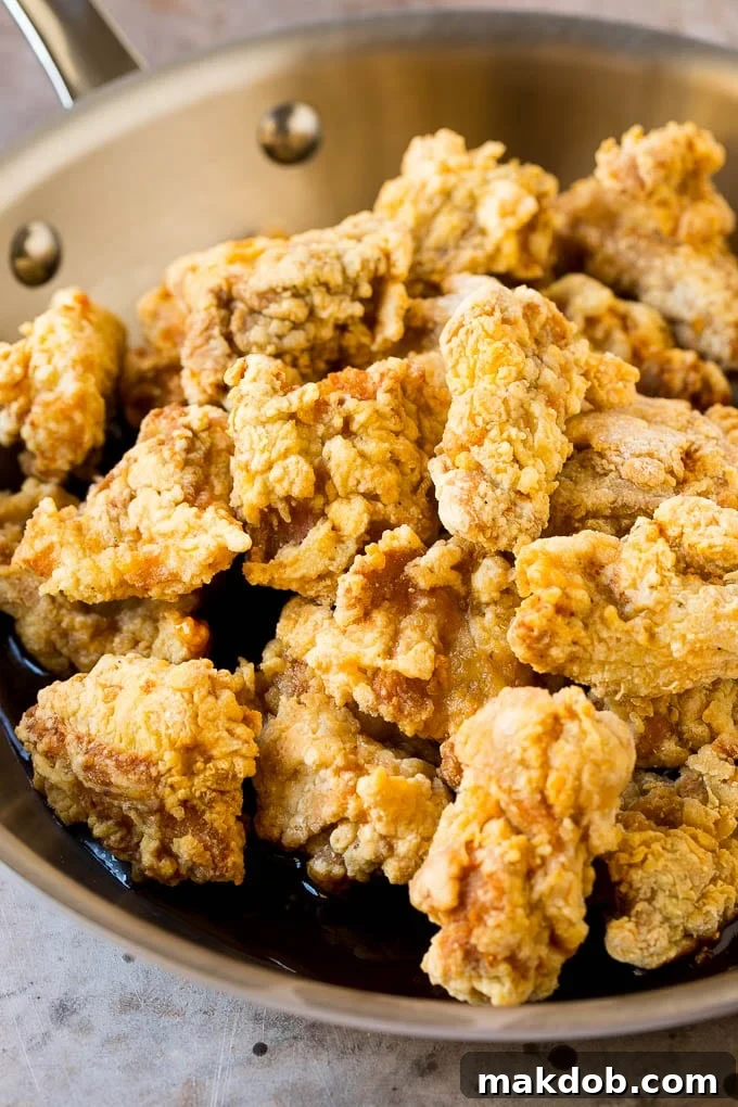 Korean Fried Chicken Recipe | Fried Chicken | Korean Chicken #chicken #friedchicken #appetizer #dinner #dinneratthezoo Fried chicken thigh pieces in a pan of sweet and savory Korean sauce.