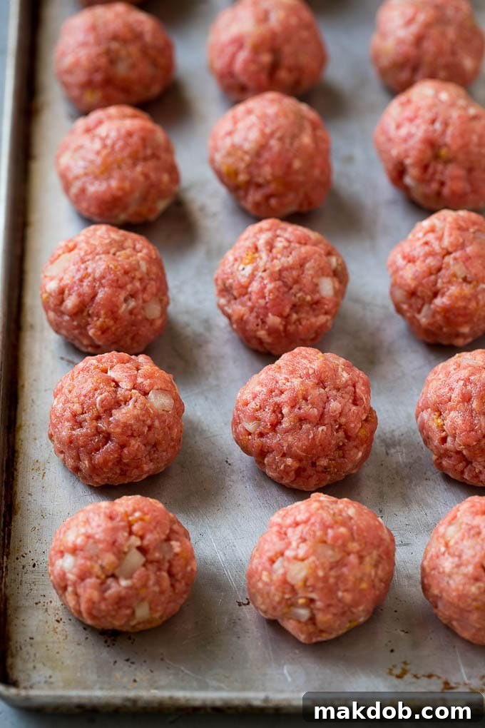Sweet and Sour Meatballs Recipe | Slow Cooker Meatballs | Crockpot Meatballs | Cocktail Meatballs #meatballs #beef #slowcooker #crockpot #dinner #appetizer #dinneratthezoo Homemade meatballs on a sheet pan.