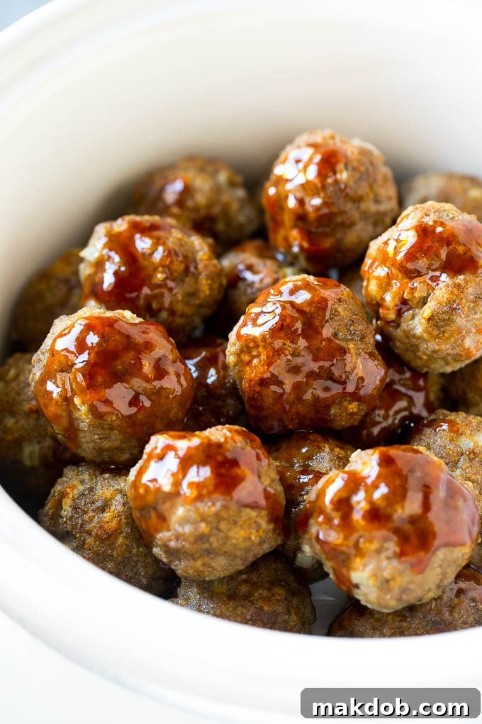 Sweet and Sour Meatballs Recipe | Slow Cooker Meatballs | Crockpot Meatballs | Cocktail Meatballs #meatballs #beef #slowcooker #crockpot #dinner #appetizer #dinneratthezoo Meatballs in a slow cooker coated in sweet and sour sauce.