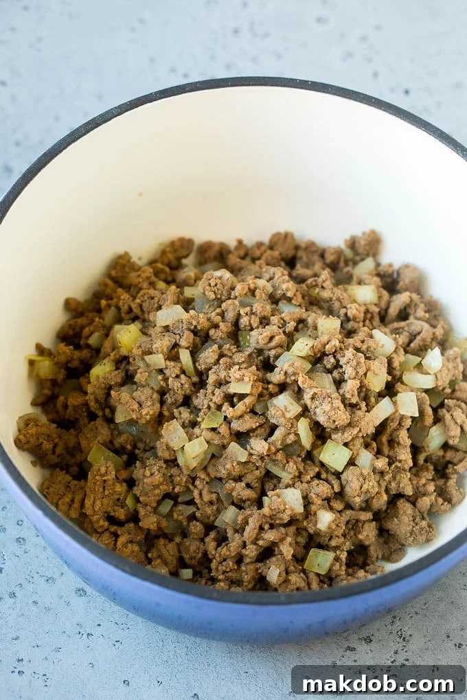 Ground beef and onions cooked in a soup pot.