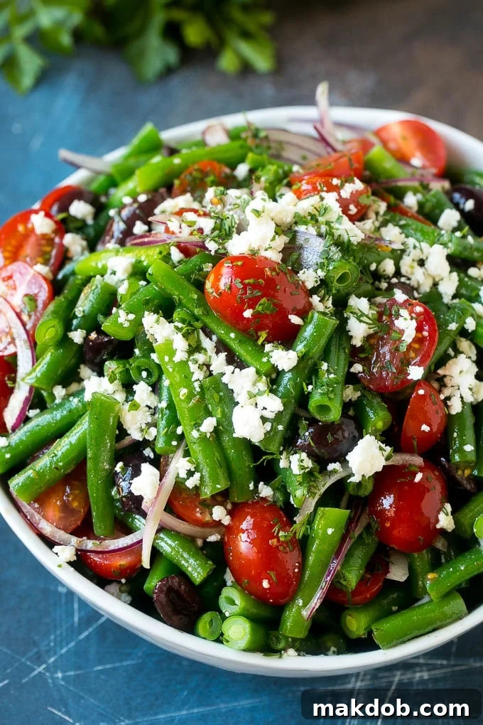 Green Bean Salad Recipe | String Bean Salad | Chopped Salad #greenbeans #tomatoes #olives #salad #cleaneating #lowcarb #glutenfree #dinneratthezoo A bowl of green bean salad made with feta cheese, tomatoes, red onion and kalamata olives.