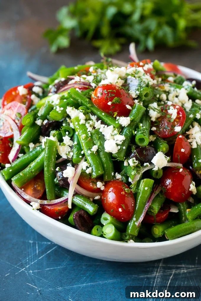 Green Bean Salad Recipe | String Bean Salad | Chopped Salad #greenbeans #tomatoes #olives #salad #cleaneating #lowcarb #glutenfree #dinneratthezoo Green bean salad tossed in a vinaigrette and topped with feta cheese and herbs.