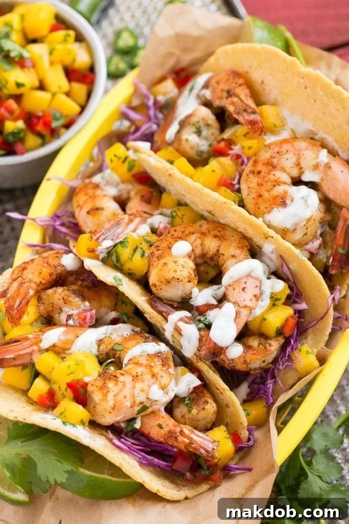 Shrimp tacos with fresh mango salsa and creamy sauce.
