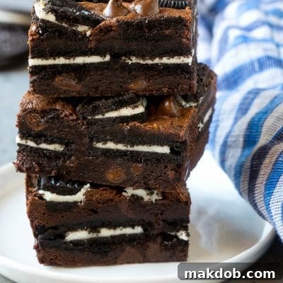 A stack of Oreo brownies filled with sandwich cookies and chocolate chips.