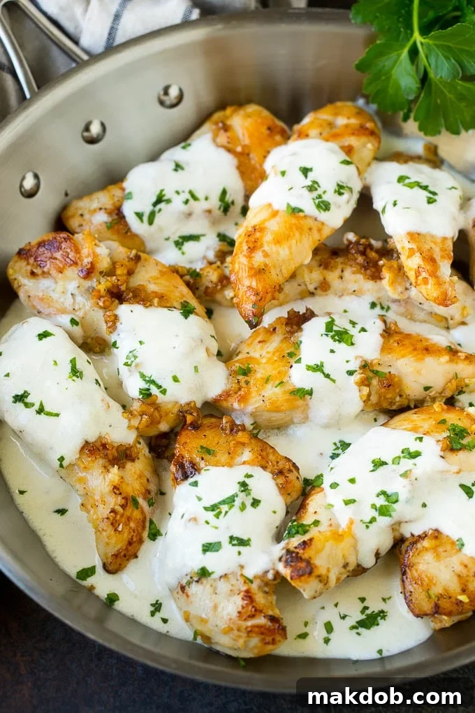 Creamy Garlic Chicken Recipe | Chicken Breast Tenders | Sauteed Chicken #chicken #garlic #parmesan #dinner #glutenfree #keto #lowcarb #dinneratthezoo A pan of garlic chicken in a creamy parmesan sauce.