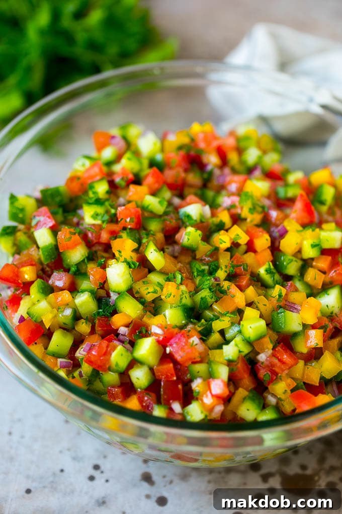 Israeli salad with cucumbers and tomatoes in a serving bowl.