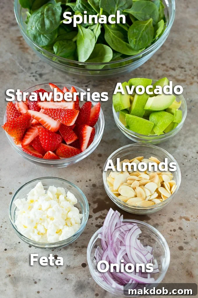 Bowls of ingredients like feta cheese, almonds, red onion and avocado.