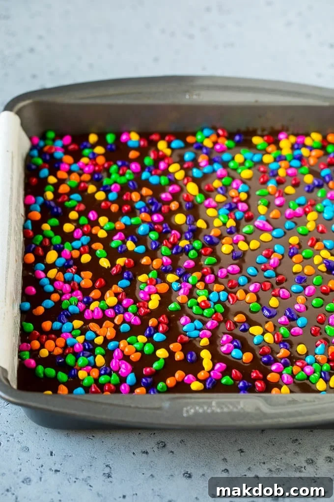 A pan of cosmic brownies with rainbow sprinkles on top.