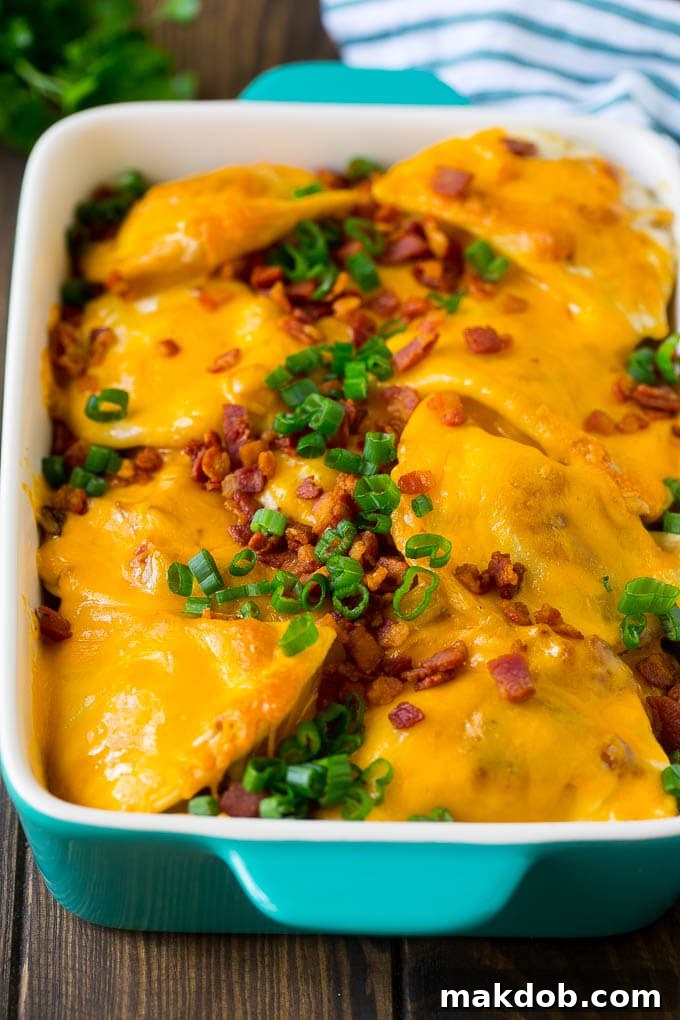Pierogi Casserole Recipe | Potato Casserole #pierogis #casserole #bacon #cheddar #dinner #dinneratthezoo A baked pierogi casserole topped with melted cheese, bacon and green onions.