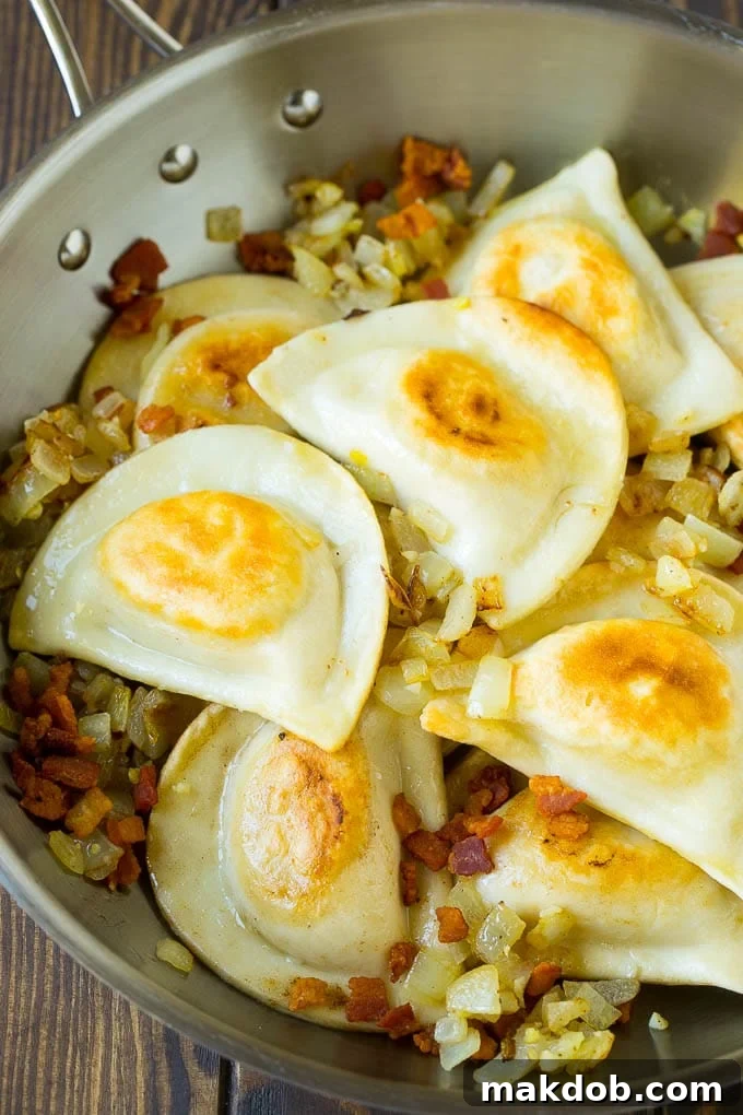 Pierogi Casserole Recipe | Potato Casserole #pierogis #casserole #bacon #cheddar #dinner #dinneratthezoo Sauteed pierogis with bacon and onions in a skillet.