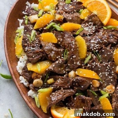 Mandarin Orange Beef 3 Orange beef in a pan served over rice.