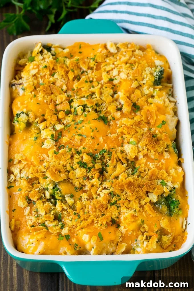 Baked Chicken Casserole with Crunchy Topping A close-up of a freshly baked chicken casserole, showing the golden, bubbly cheese and crunchy cracker topping, with steam gently rising.