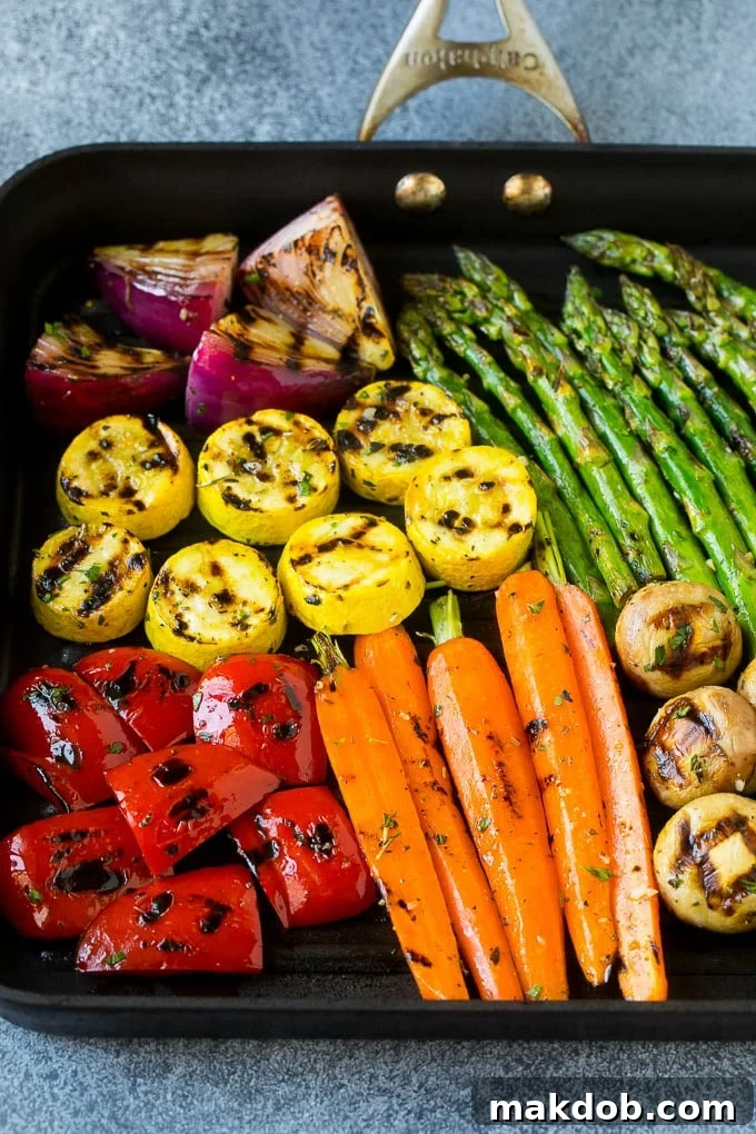 A grill pan with an assortment of vegetables cooking on it, showing the early stages of charring and tenderness, creating beautiful grill marks.