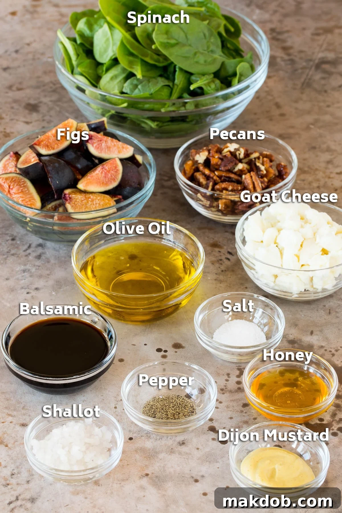 A curated selection of fresh fig salad ingredients, including ripe figs, creamy goat cheese, crunchy candied pecans, vibrant olive oil, and aromatic seasonings, arranged in elegant bowls.