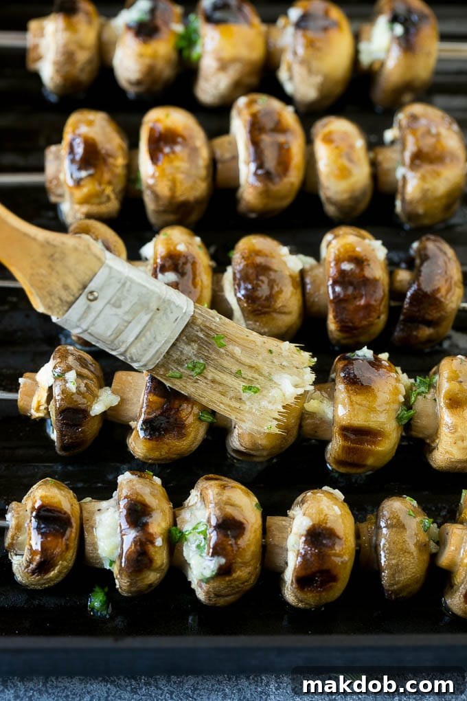 Grilled Mushrooms Recipe | Mushroom Kabobs | Mushroom Side Dish #mushroom #grilling #garlic #keto #lowcarb #dinneratthezoo Mushroom kabobs being brushed with fragrant garlic butter directly on the grill.