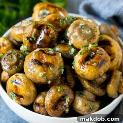Grilled Mushroom Bliss 2 Grilled mushrooms coated with garlic butter in a serving bowl.